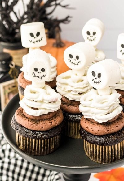 Skeleton Cupcakes on a black cake stand.