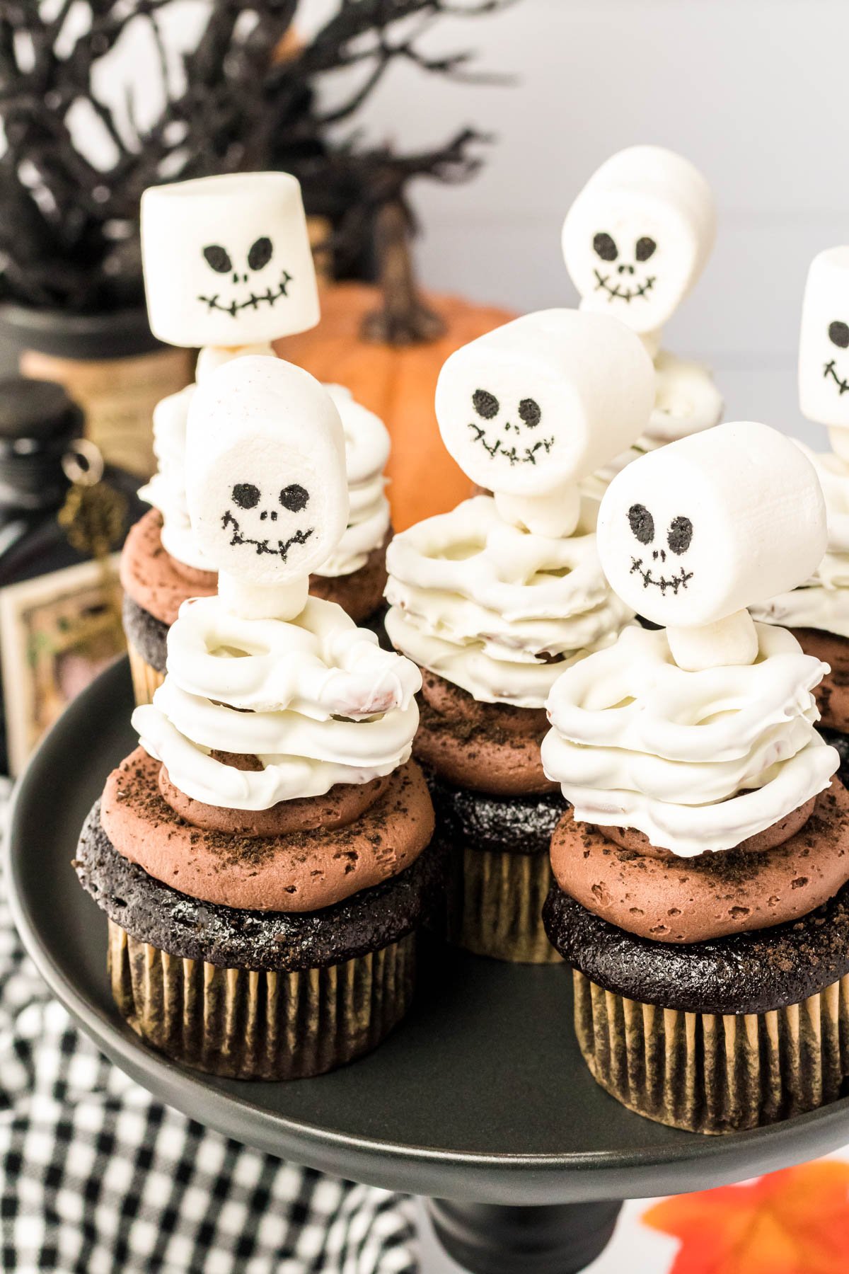 Skeleton Cupcakes on a black cake stand.