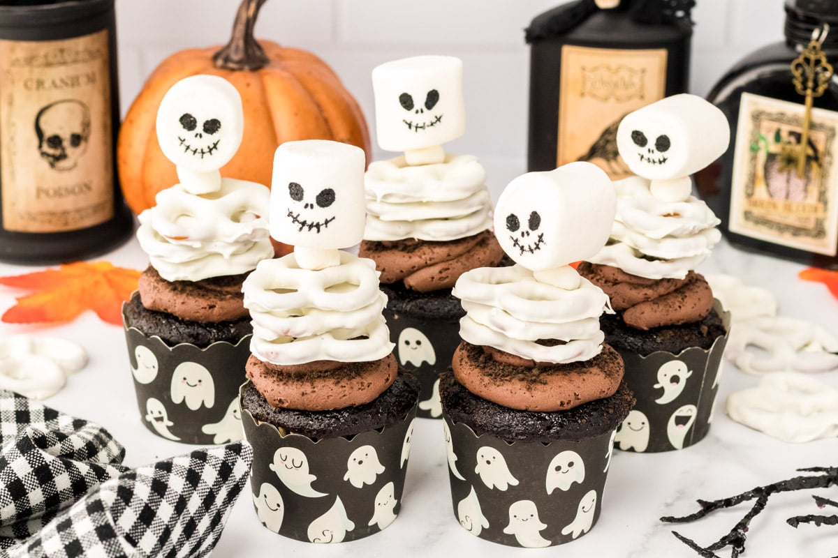 Skeleton cupcakes on a white table.