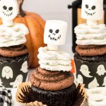 Close up of Halloween Cupcakes decorated like skeletons.