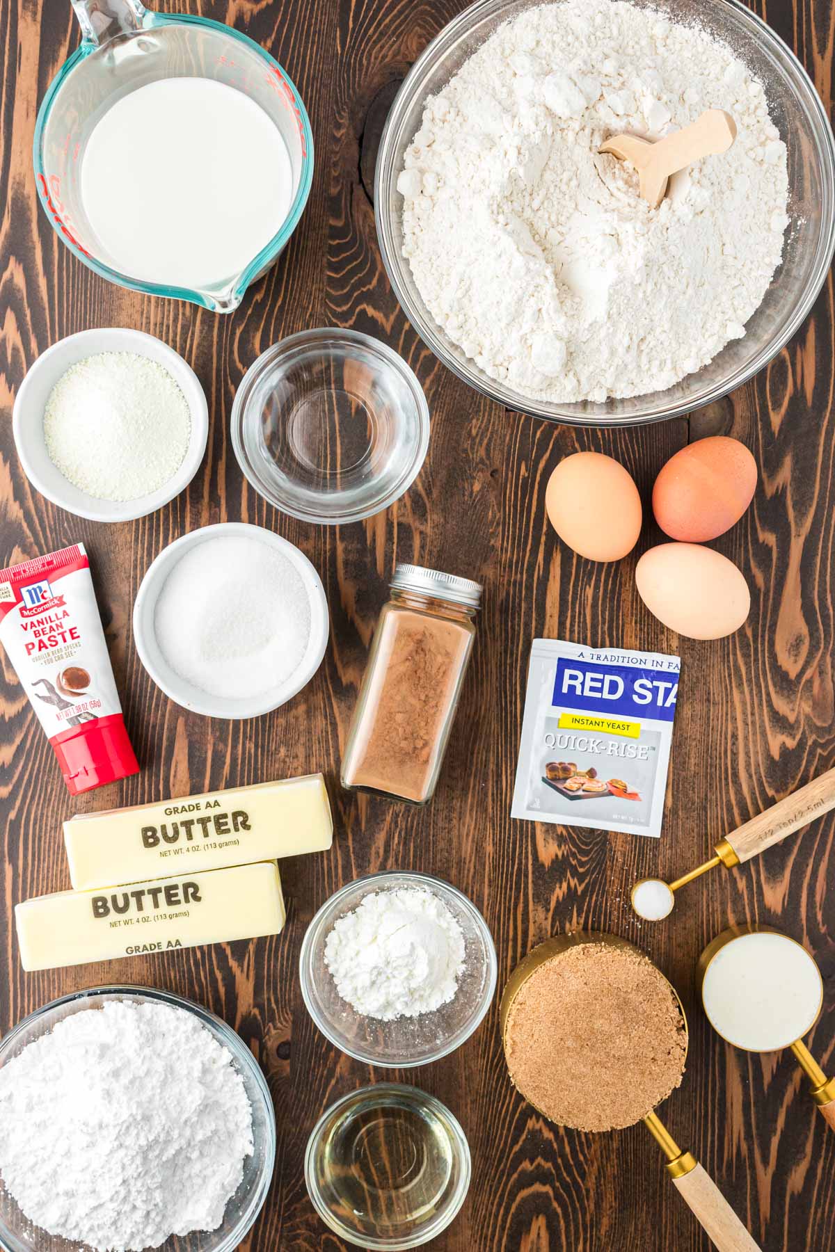 Ingredients to make tangzhong cinnamon rolls on a wooden table.