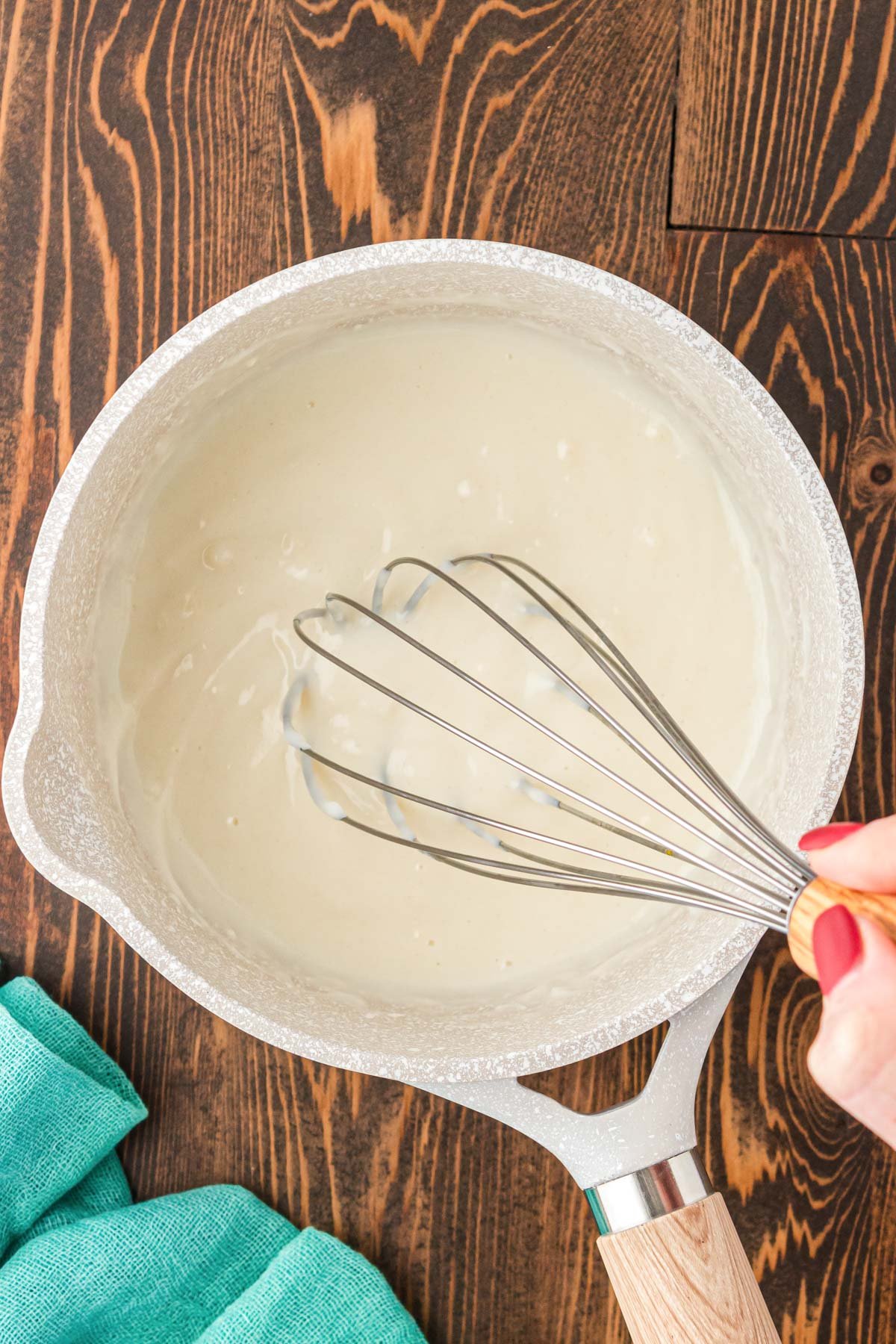 Tangzhong mixture in a small pot being whisked.