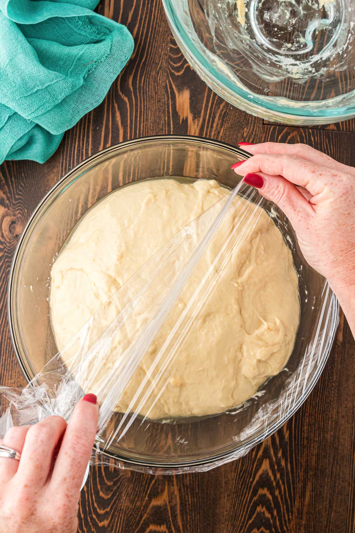 Cinnamon roll dough going in a bowl to rise. 