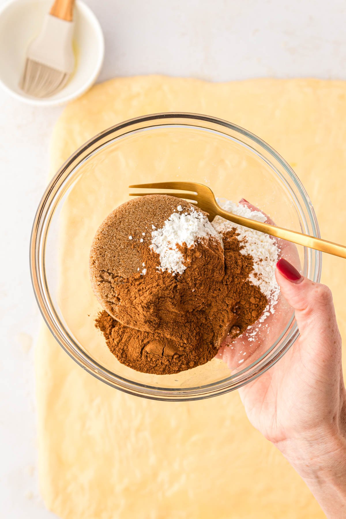 Dark brown sugar, cinnamon, and cornstarch in a small bowl.