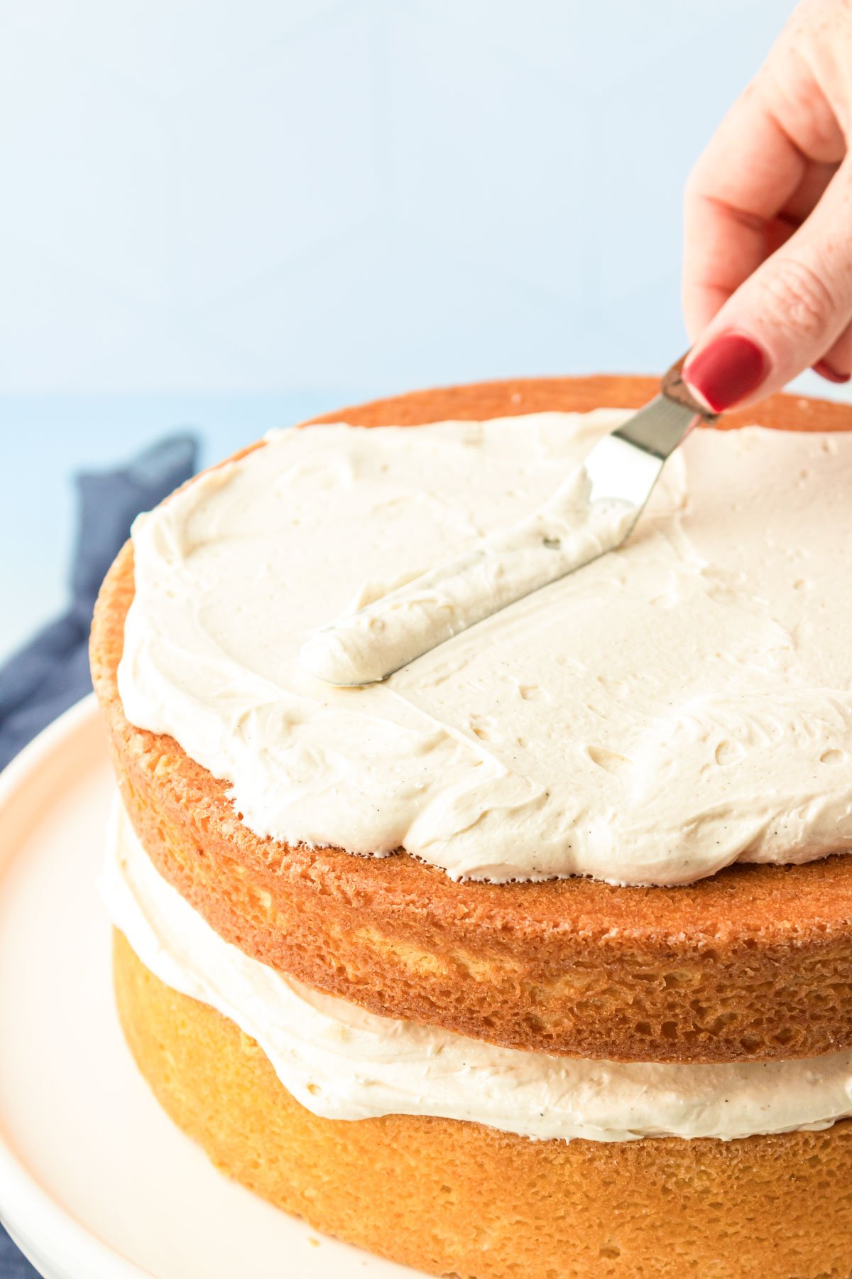 American Buttercream Frosting with vanilla bean being spread on a cake.