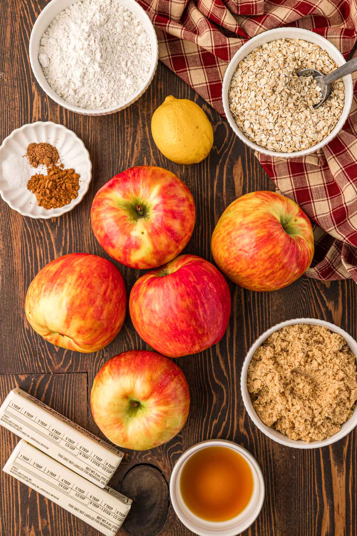 Overhead photo of ingredients to make apple crisp on a wooden table.