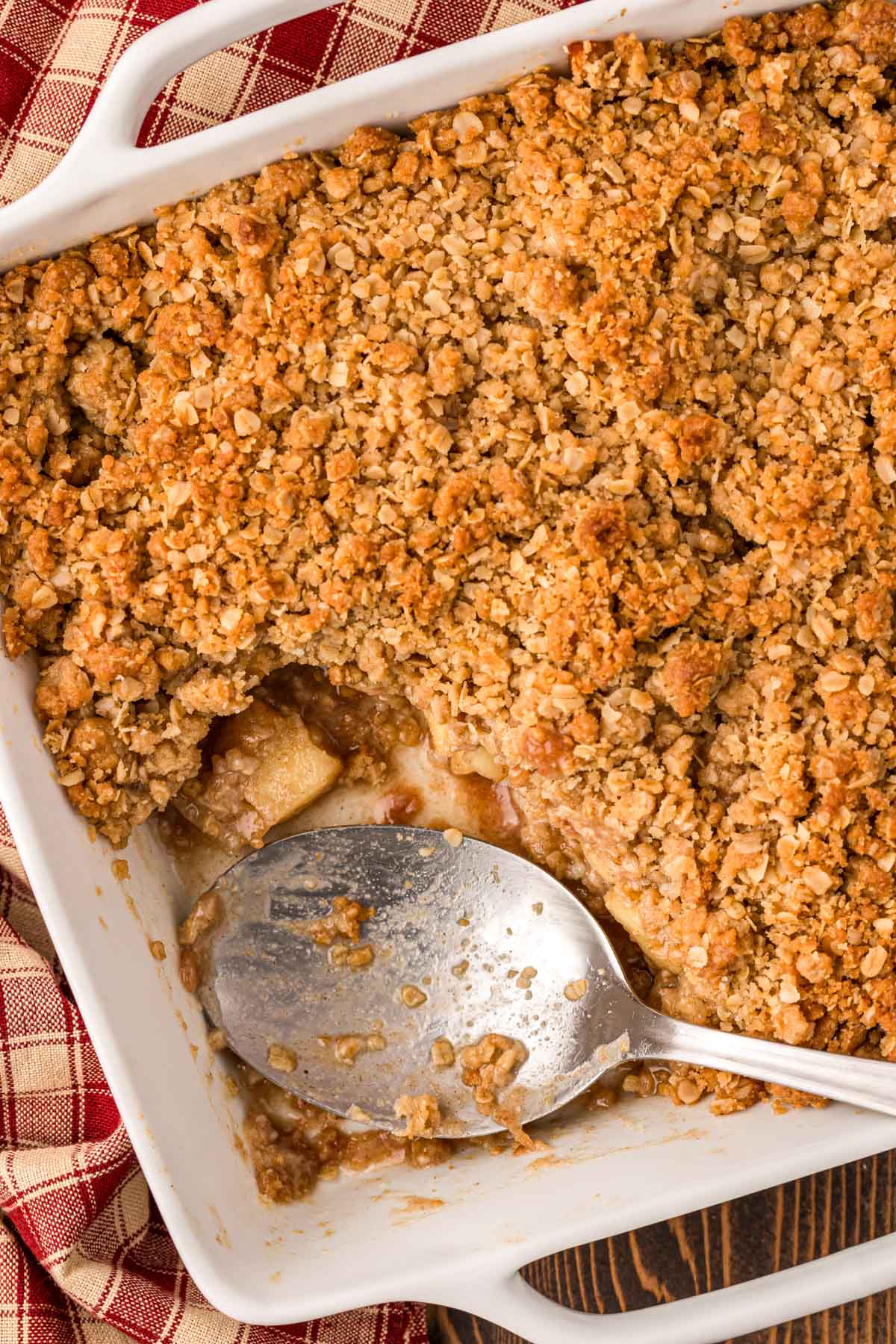 Overhead photo of apple crisp with a serving spoon in it.