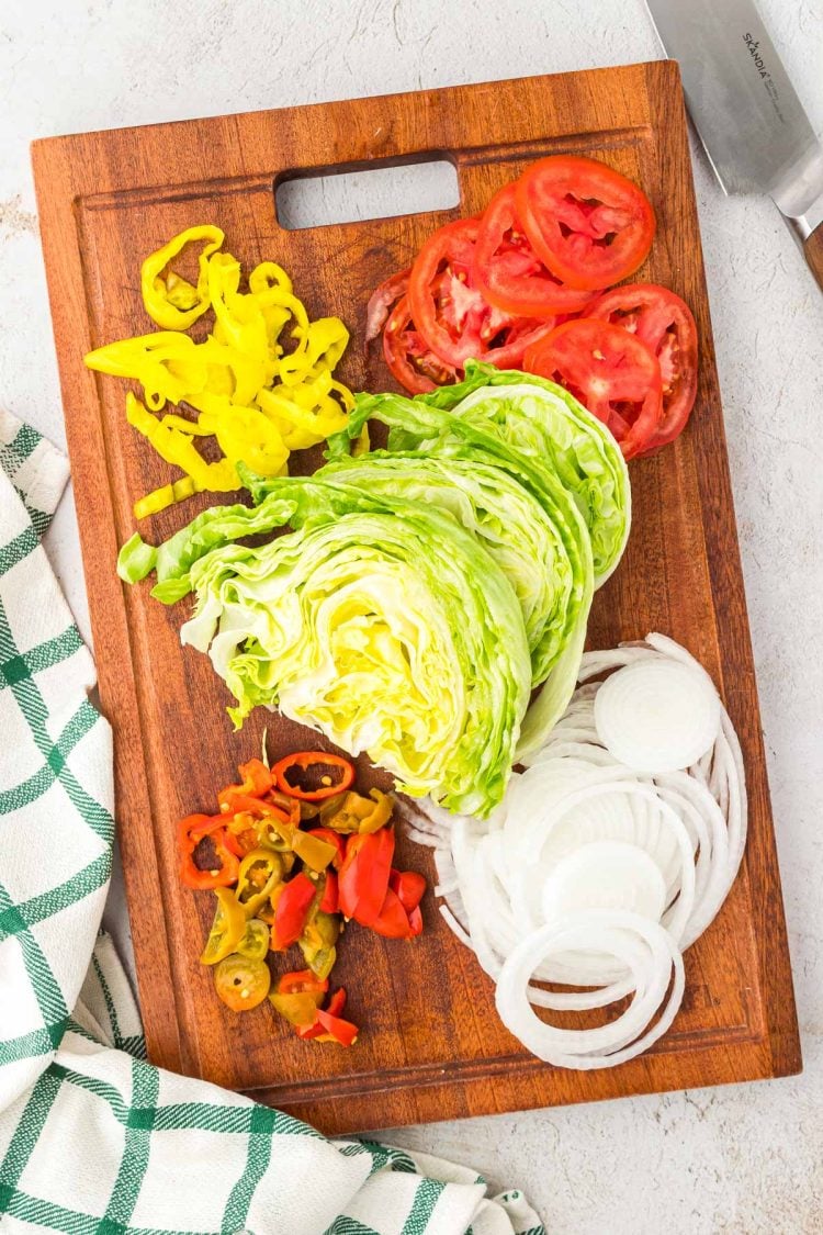 Veggies on a wooden cutting board.