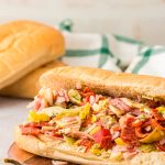 TikTok chopped Italian Sandwich on a wooden board on a table.