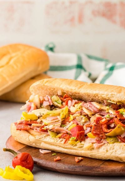 TikTok chopped Italian Sandwich on a wooden board on a table.