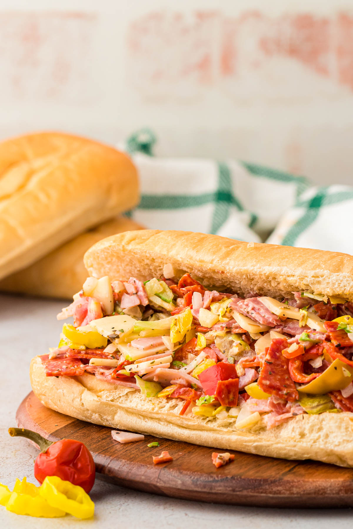 TikTok chopped Italian Sandwich on a wooden board on a table.