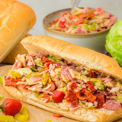 A chopped Italian Sub on a cutting board.