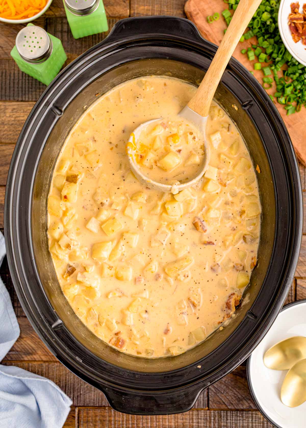 Overhead photo of a slow cooker filled with creamy potato soup.