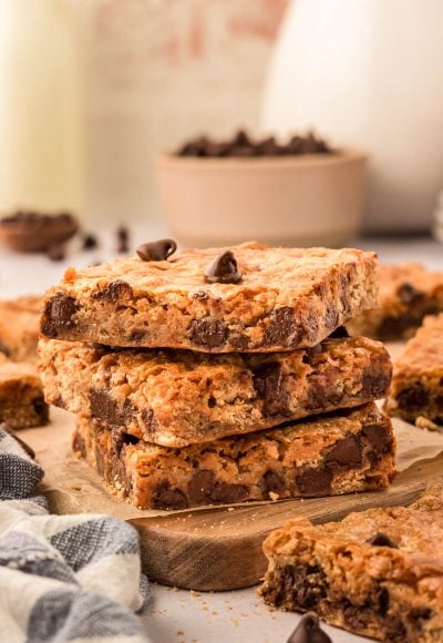 A stack of three graham cracker bars on a wooden board.