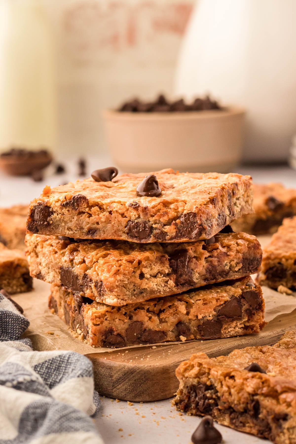 A stack of three graham cracker bars on a wooden board.