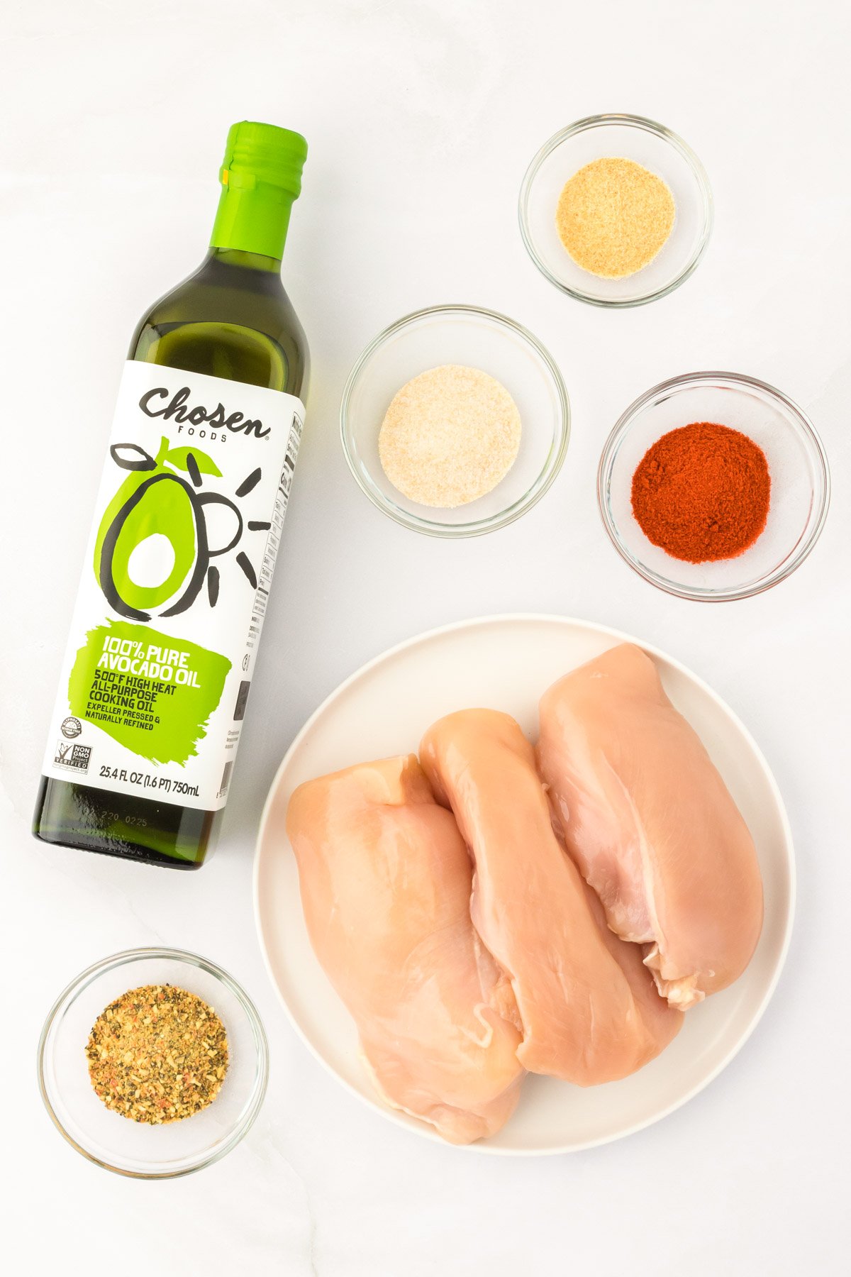 Overhead photo of ingredients used to make Juicy Chicken 1010 on a white surface.