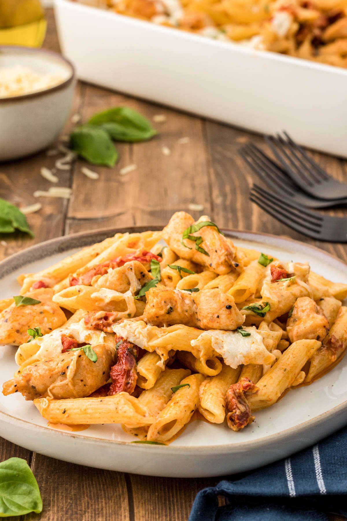 Marry Me Chicken Pasta on a plate on a wooden table.