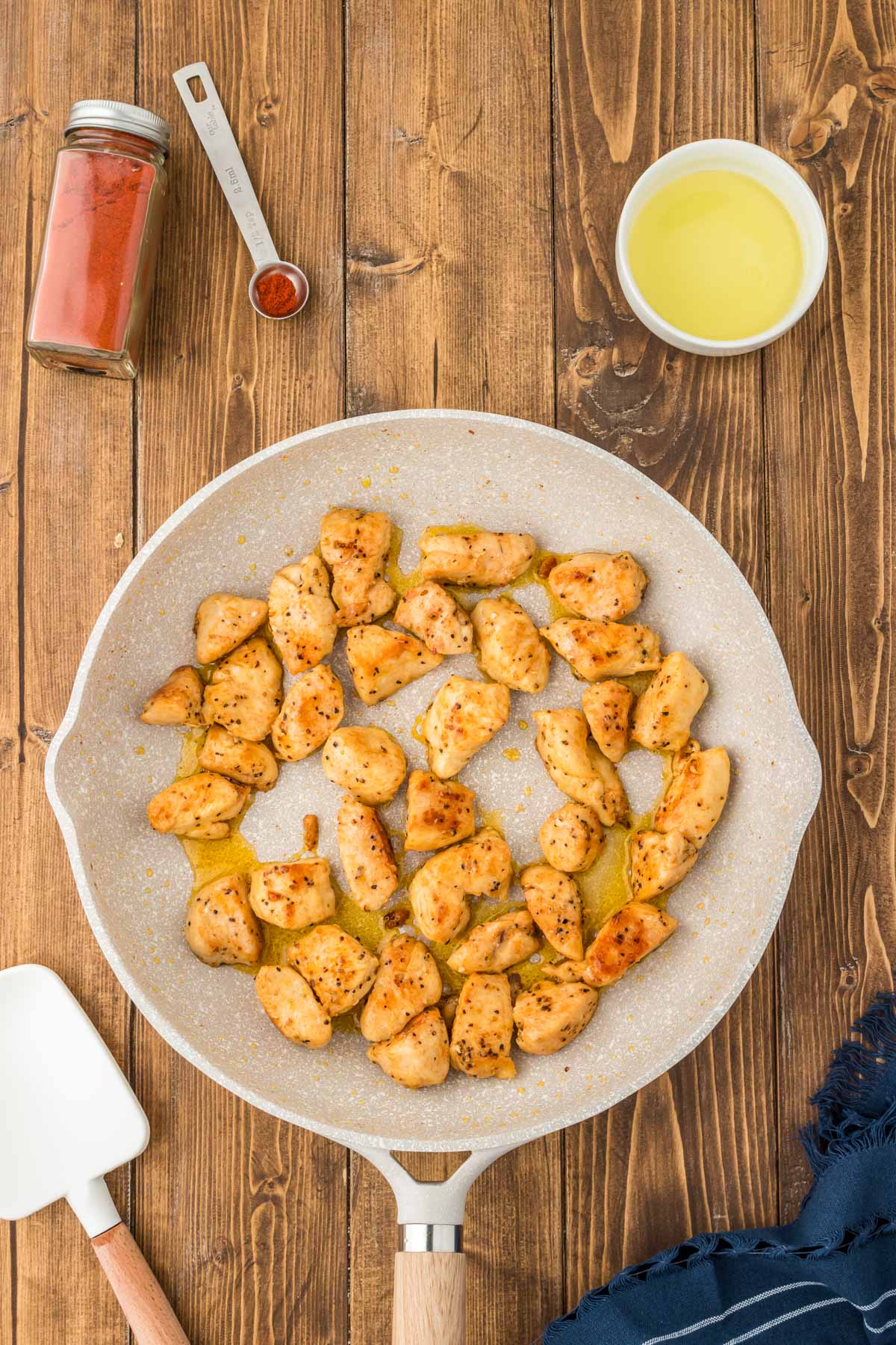 Chicken being seared in a pan.