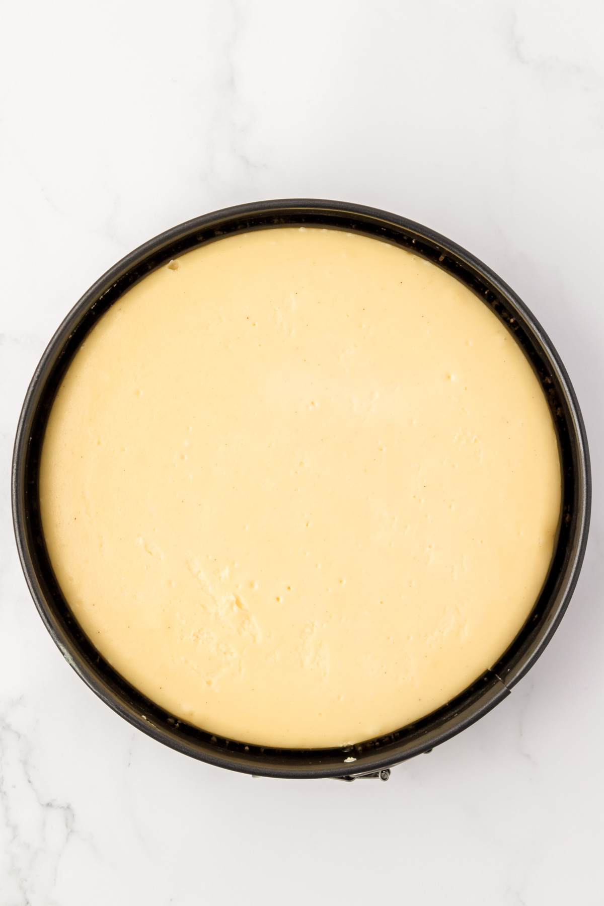 Overhead photo of a baked cheesecake.