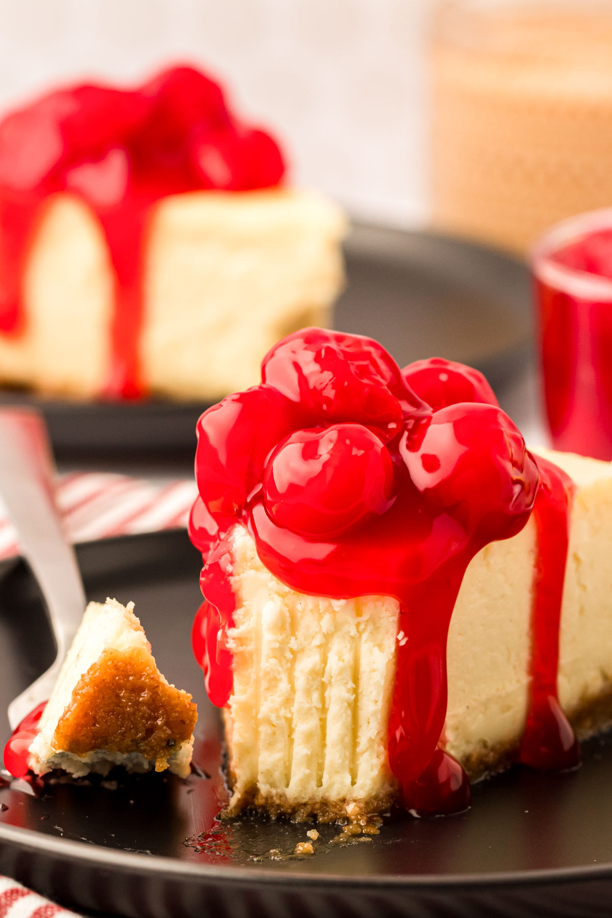 A fork taking a bite of cheesecake.