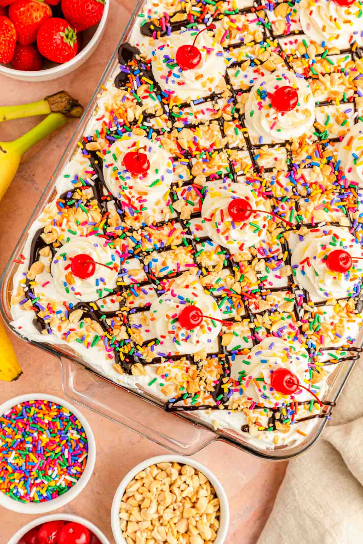 A banana split icebox cake on a pink table.