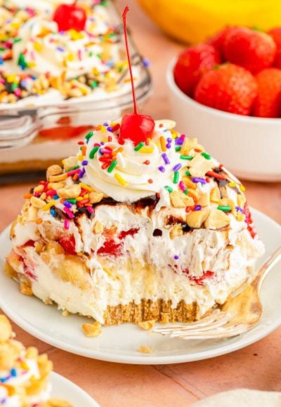 A slice of no bake banana split cake on a white plate.