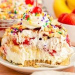 A slice of no bake banana split cake on a white plate.