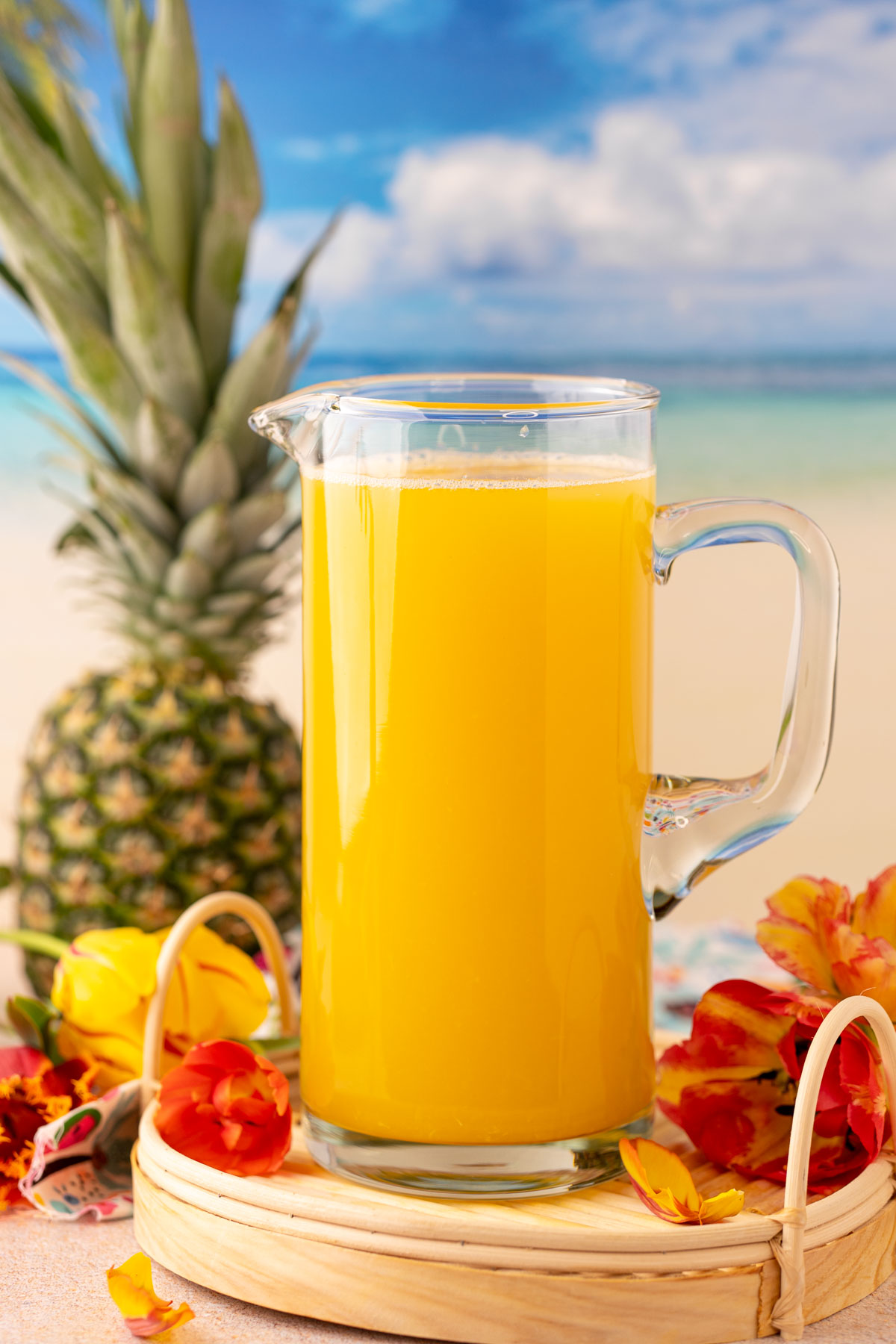 A pitcher filled with pineapple punch.