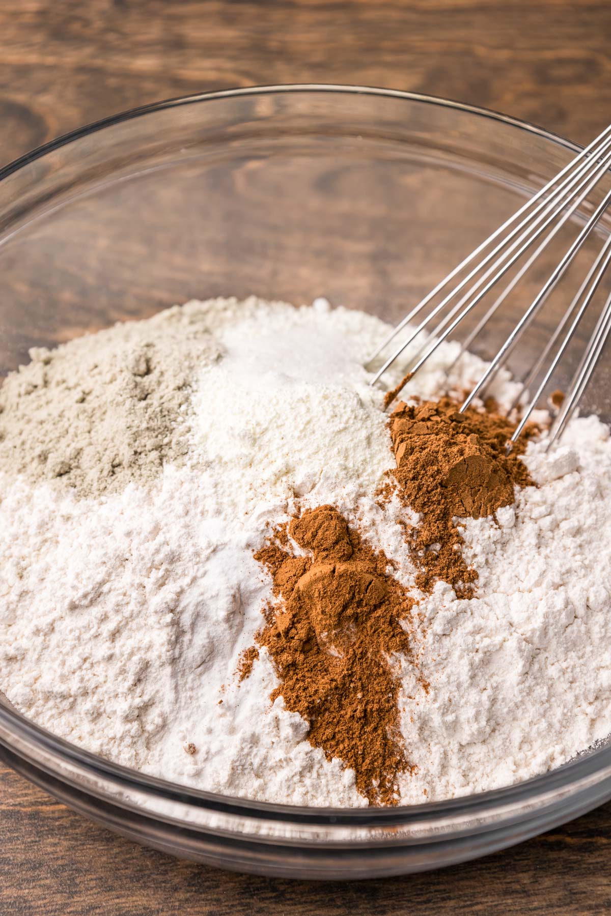 Dry ingredients for pumpkin cookies being whisked in a bowl.