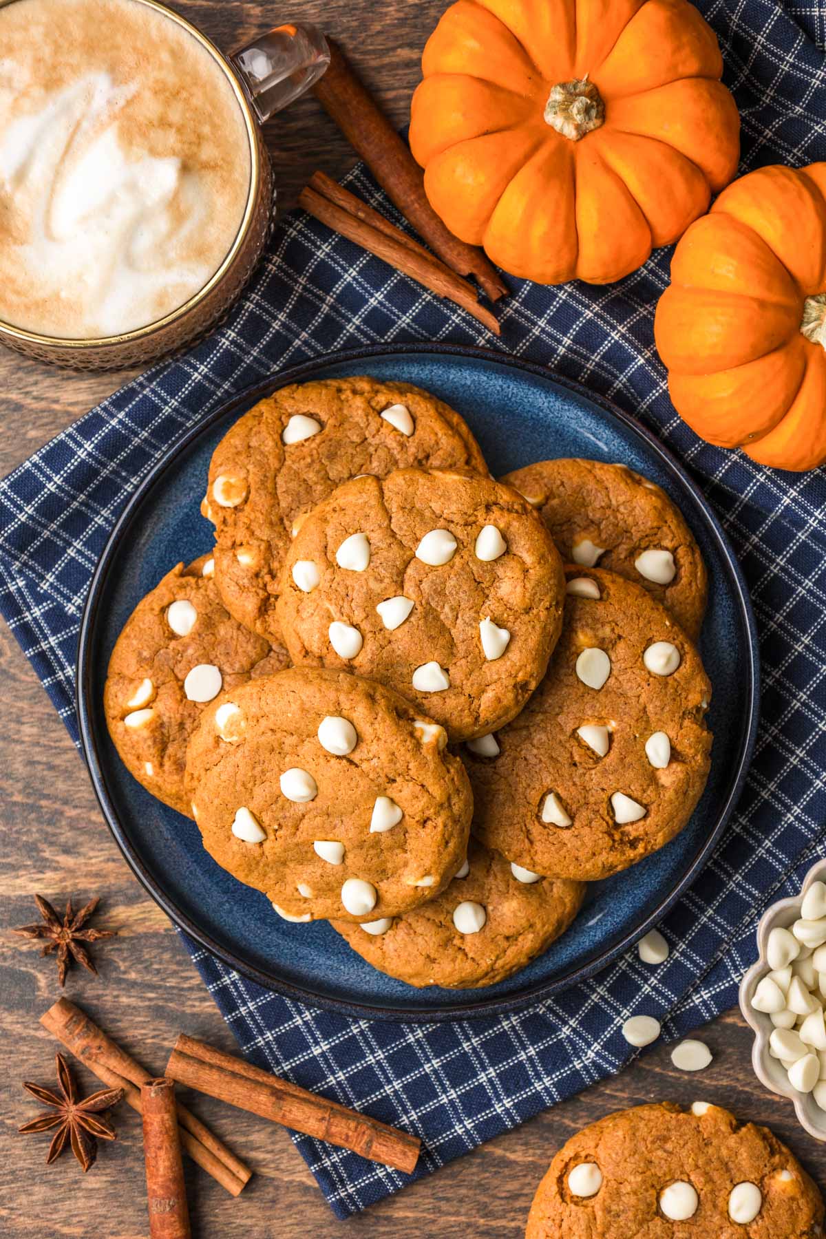 Overhead photo of pumpkin white chocolate cookies on a blue plate.