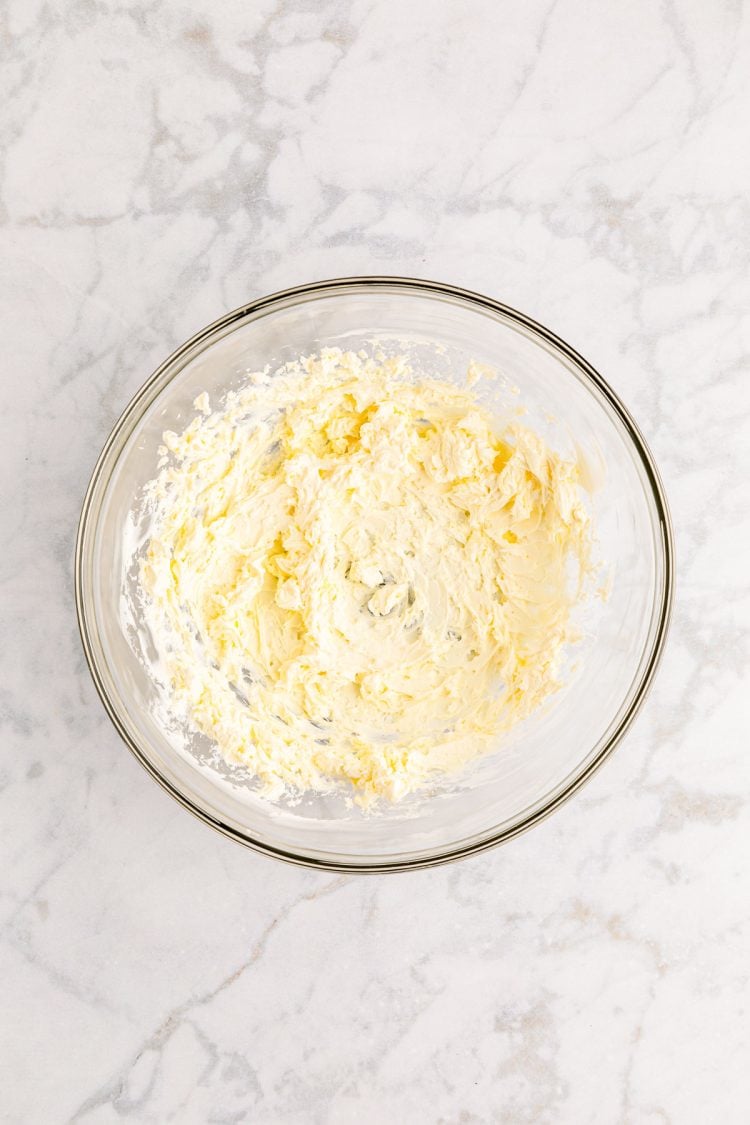 Cream cheese in a glass bowl.