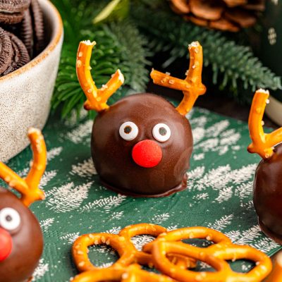 Close up of reindeer oreo balls on a green table napkin.