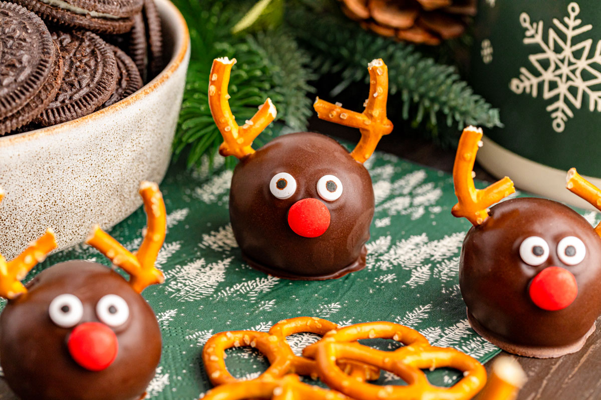 Close up of reindeer oreo balls on a green table napkin.