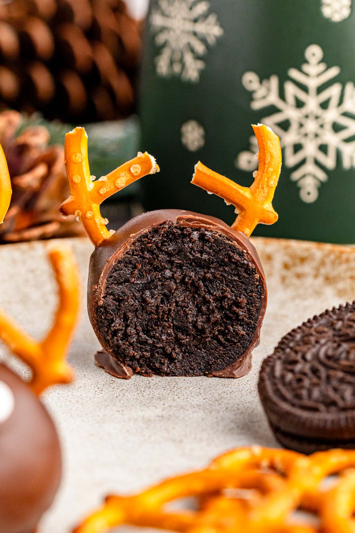 A reindeer Oreo ball that's been cut in half to show the filling.