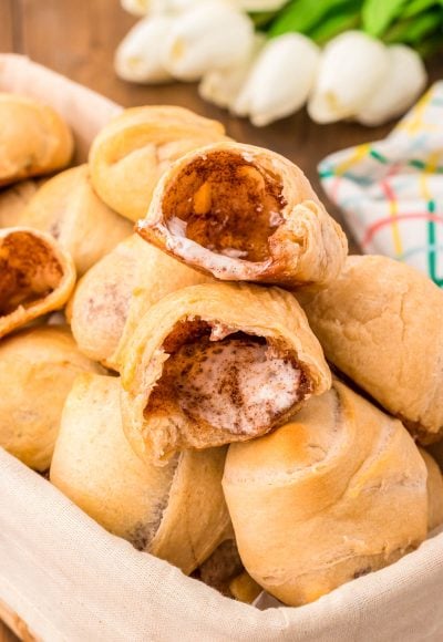 Resurrection rolls in a basket for Easter, the top one has been opened revealing the empty inside.