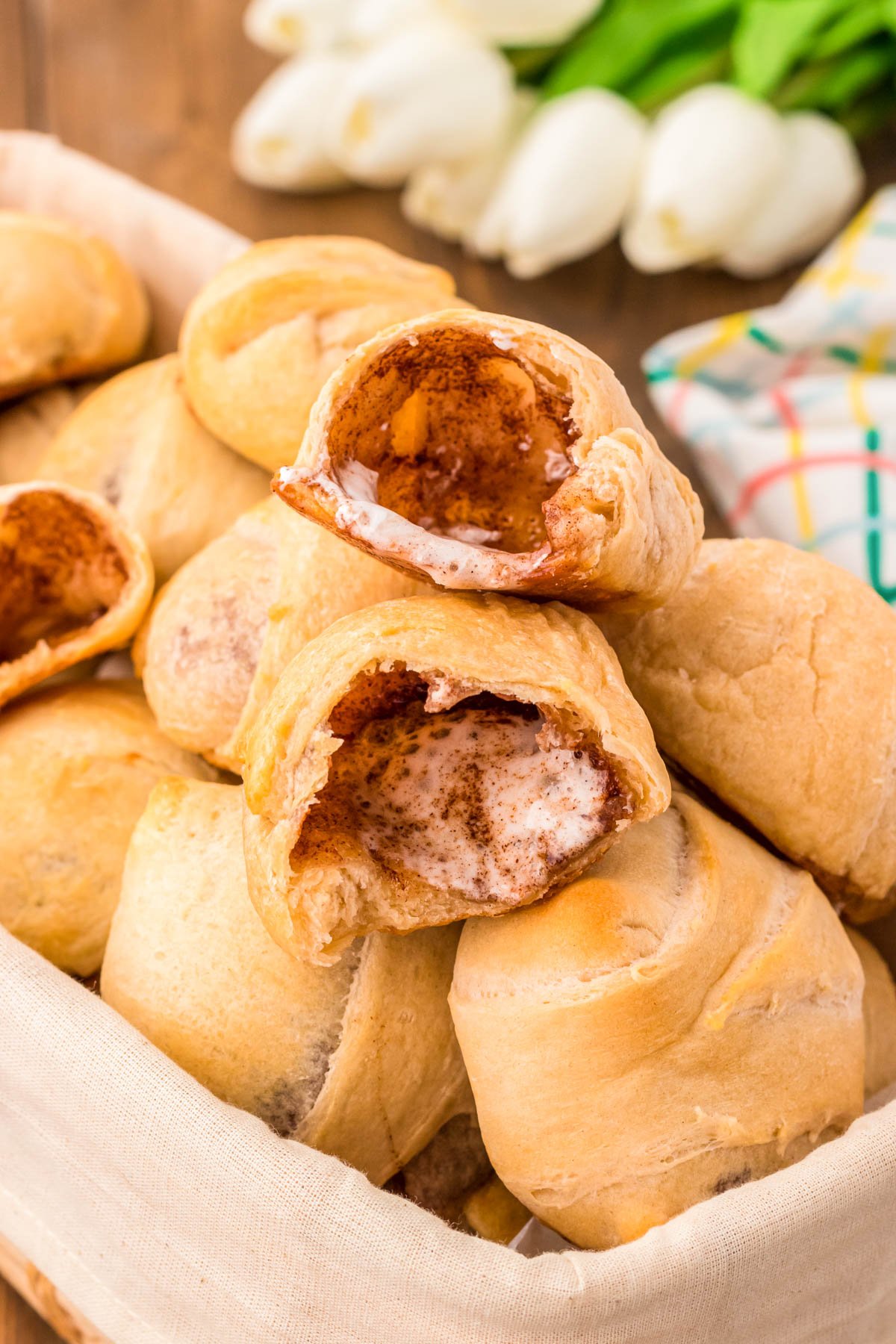 Resurrection rolls in a basket for Easter, the top one has been opened revealing the empty inside.