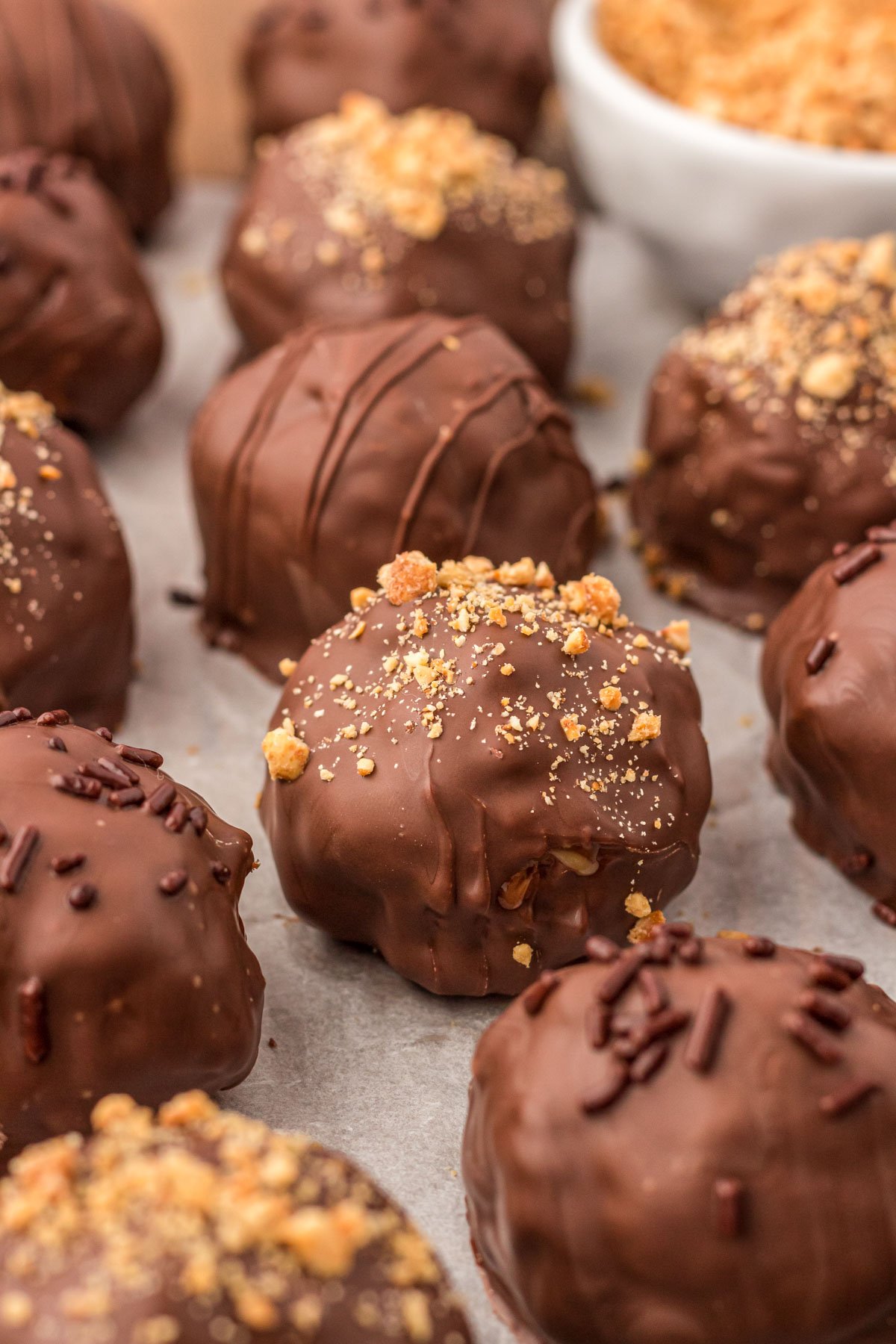 Peanut Butter Balls make with rice krispies cereal on a piece of parchment paper.