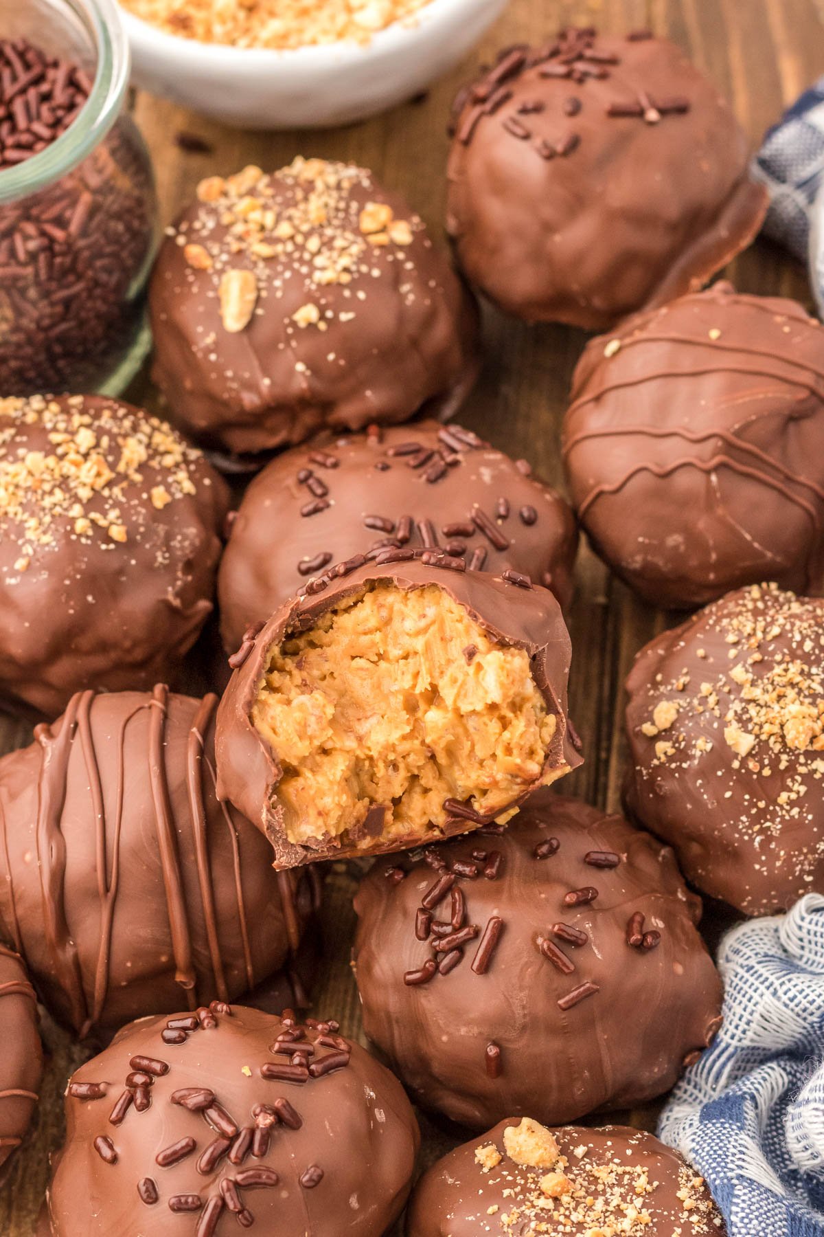 Rice Krispies Peanut Butter Balls piled on a wooden table.