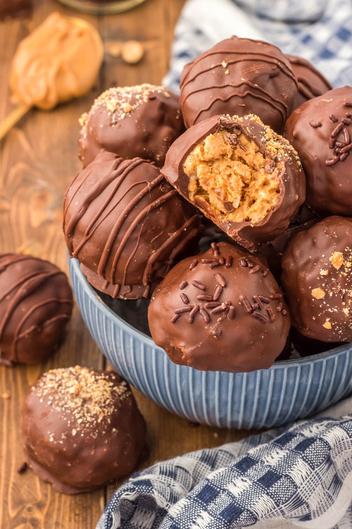 Peanut Butter Balls in a blue bowl, one is missing a bite.