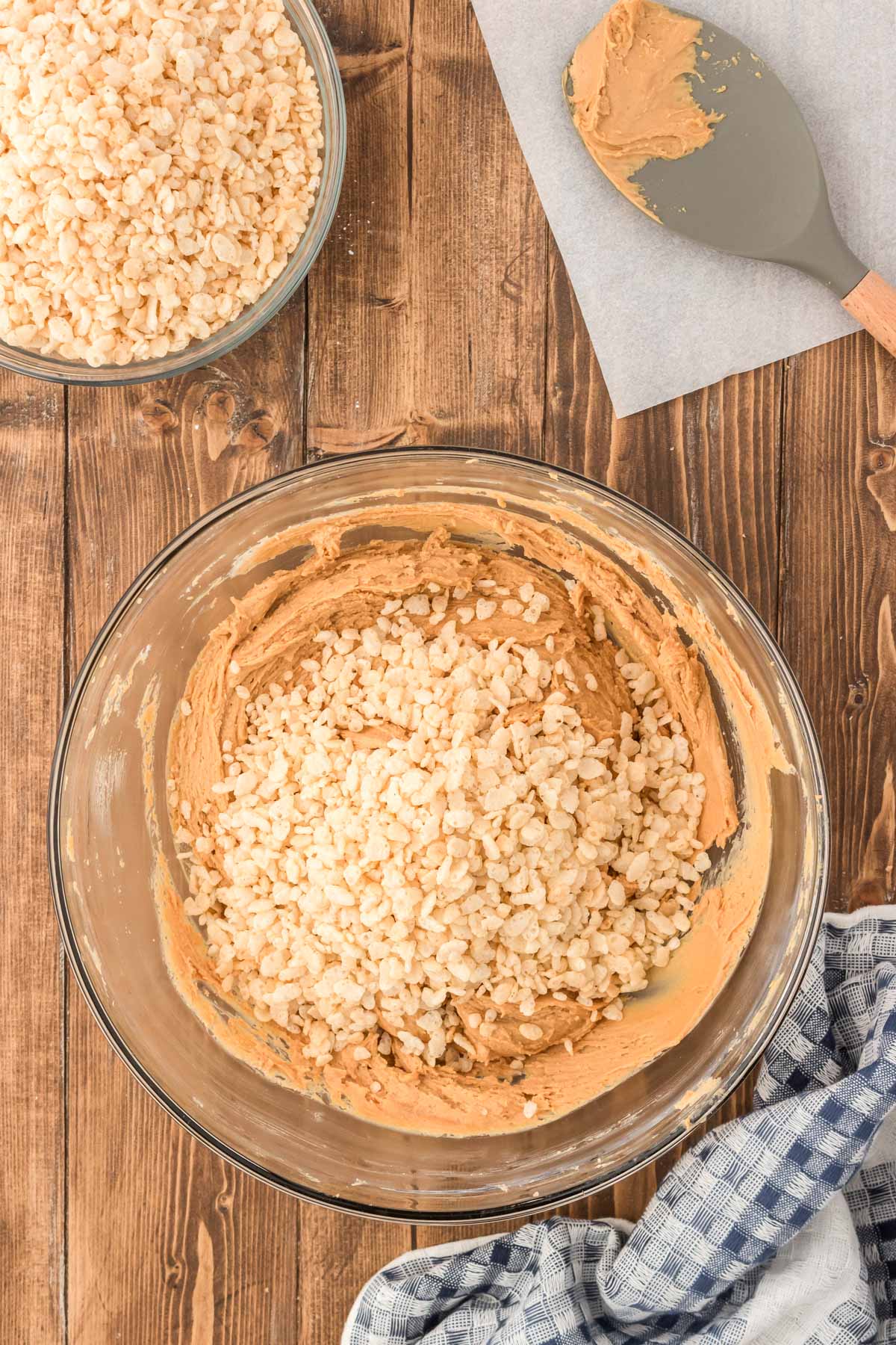 Rice krispies being mixed into peanut butter ball mixture.