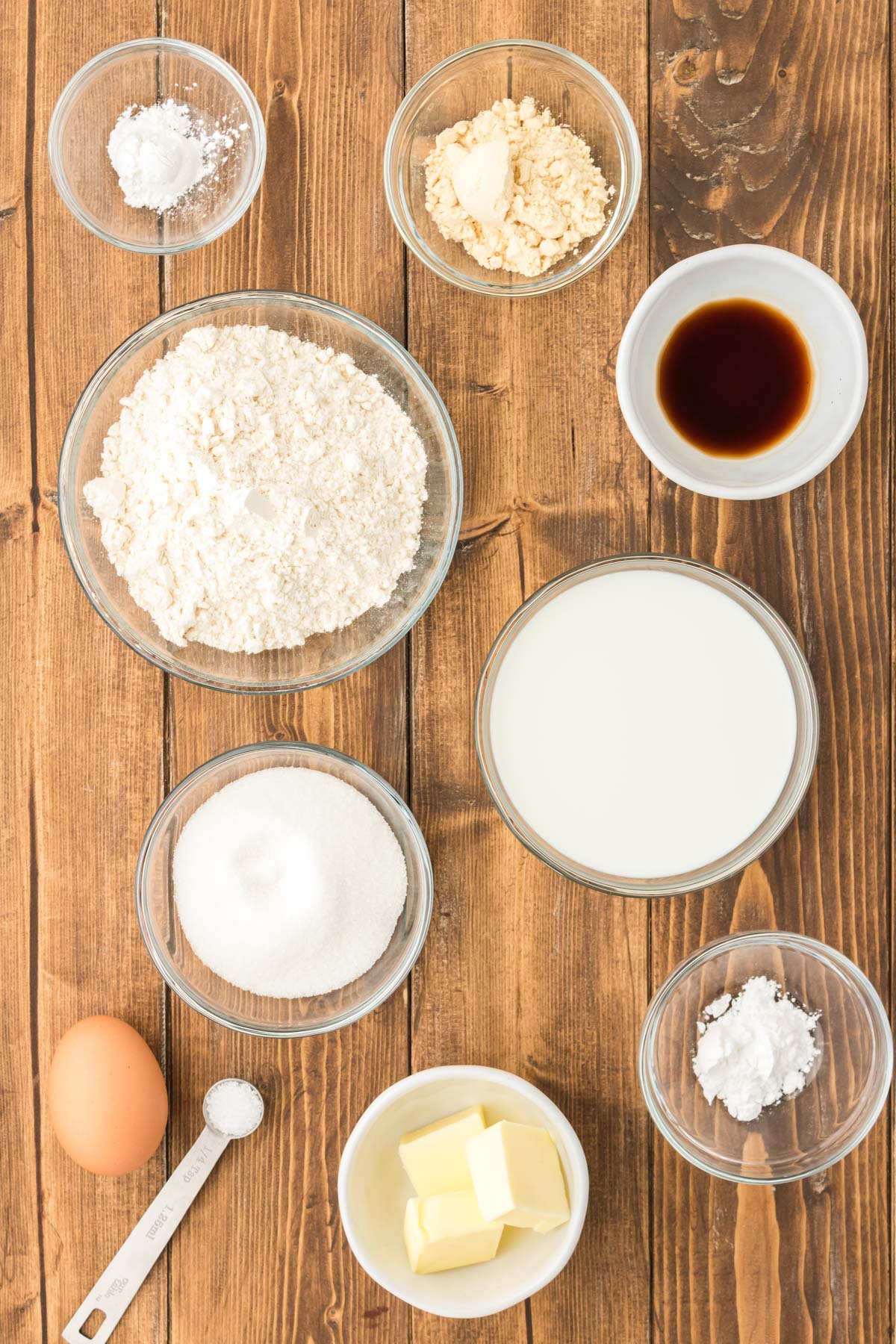 Overhead photo of ingredients used to make silver dollar pancakes on a wooden table.