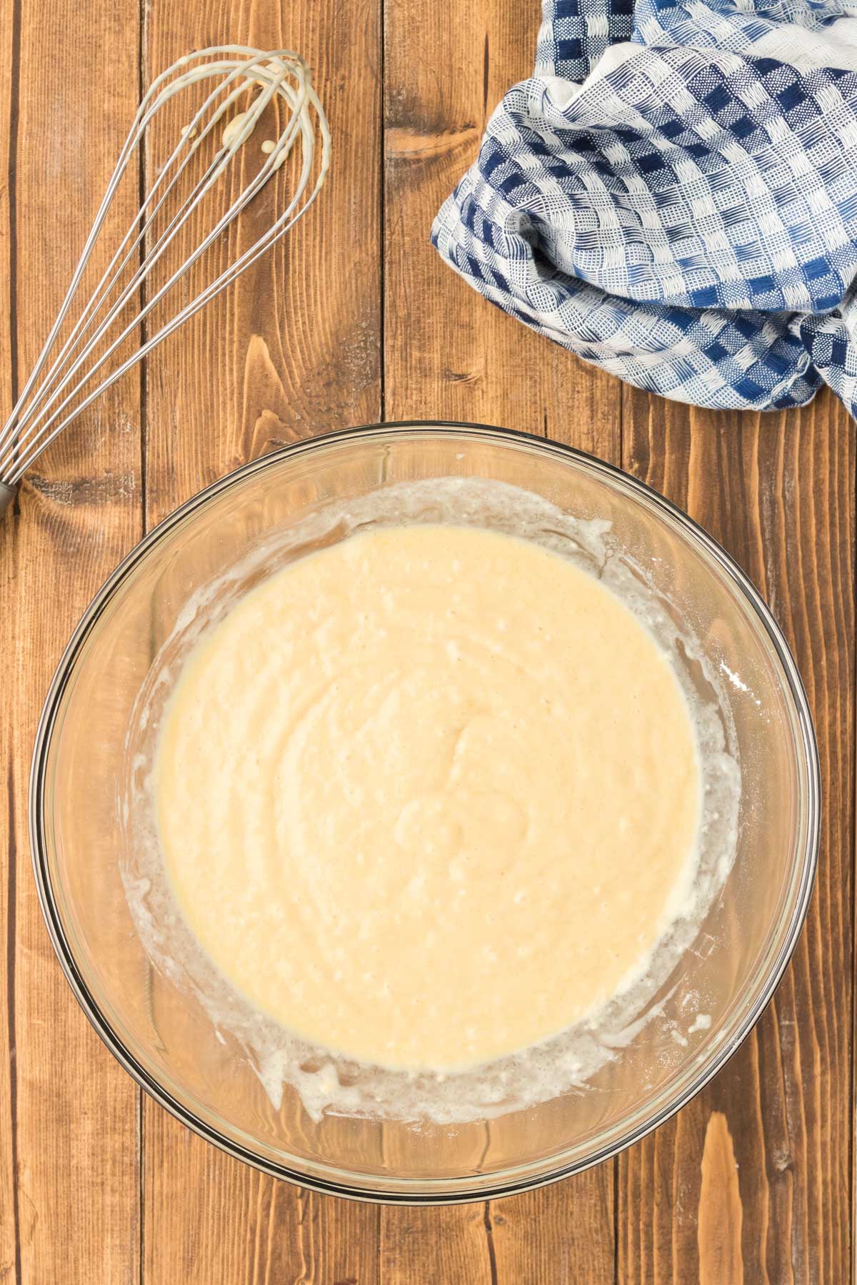 Pancakes batter resting on a wooden table.