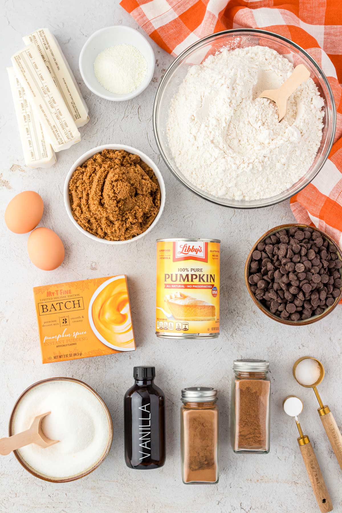 Ingredients to make pumpkin chocolate chip cookies on a table.