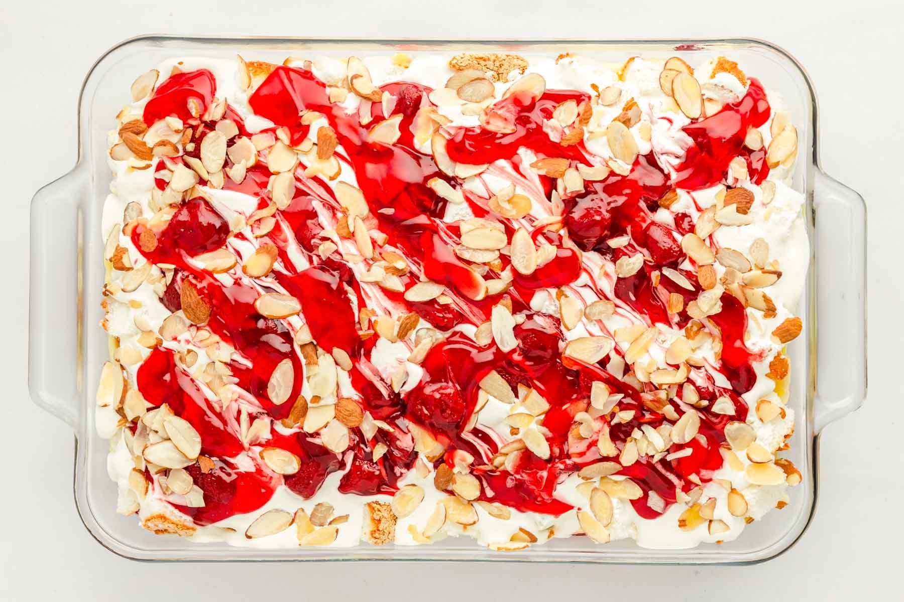 Overhead photo of a glass pan with strawberry heaven on earth cake.