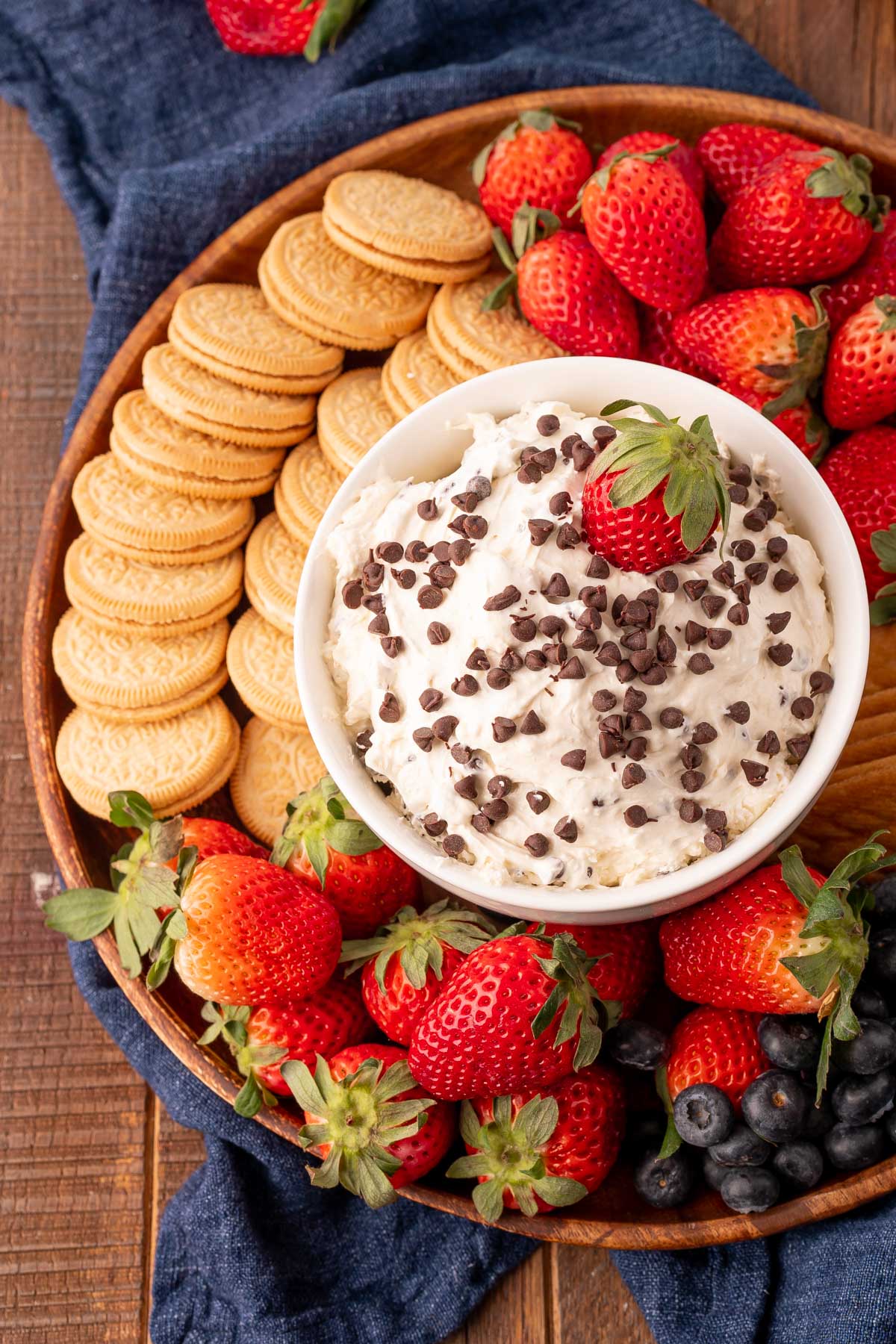 A bowl of tiktok booty dip on a platter with cookies and berries.