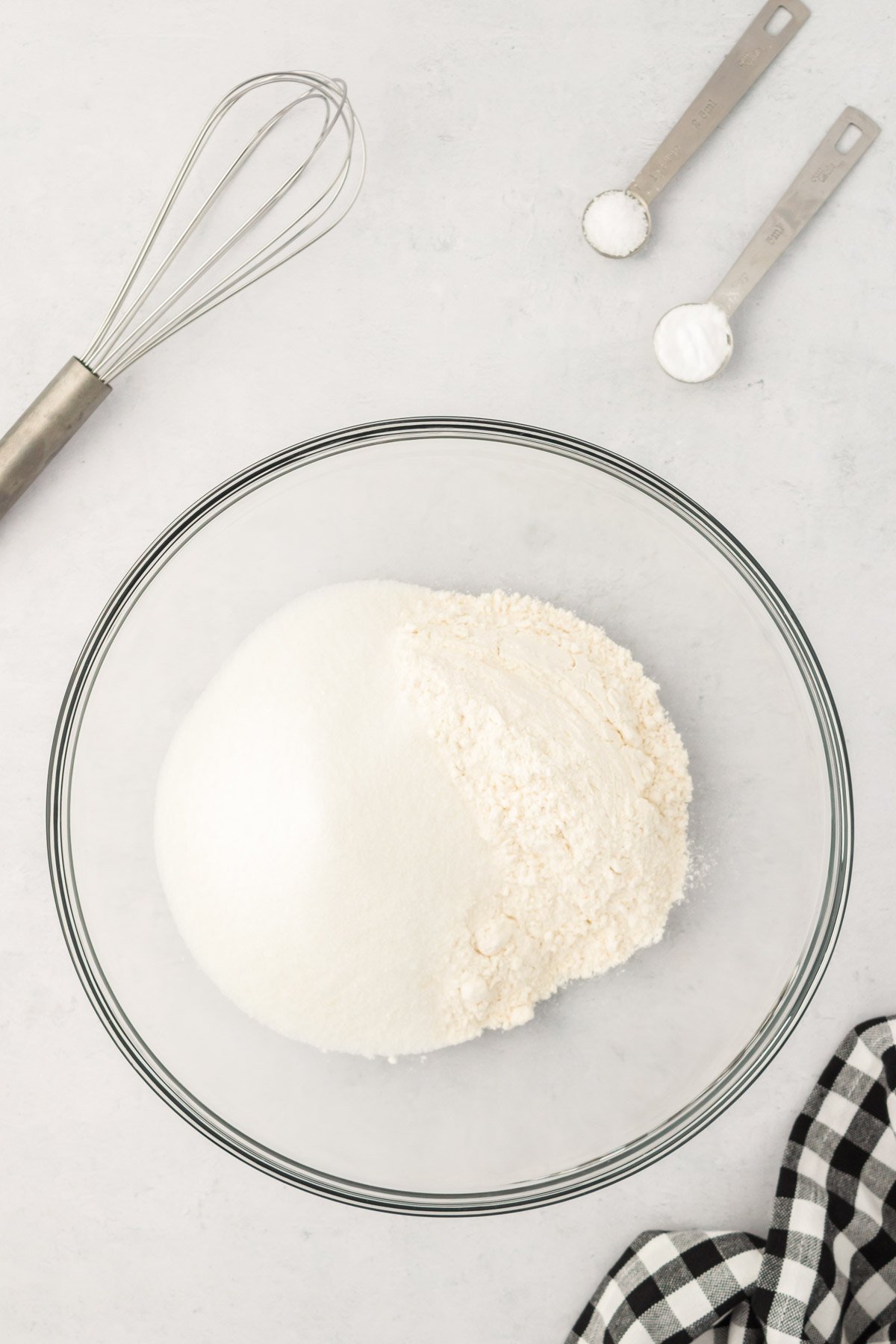 Dry ingredients for cake in a glass mixing bowl. 