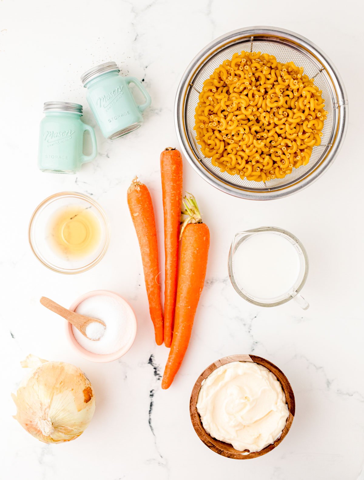 Ingredients to make Hawaiian Macaroni Salad on a marble table.