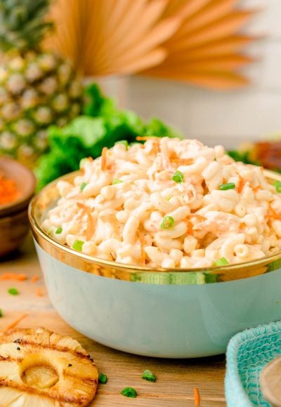 A teal bowl filled with Hawaiian macaroni salad.