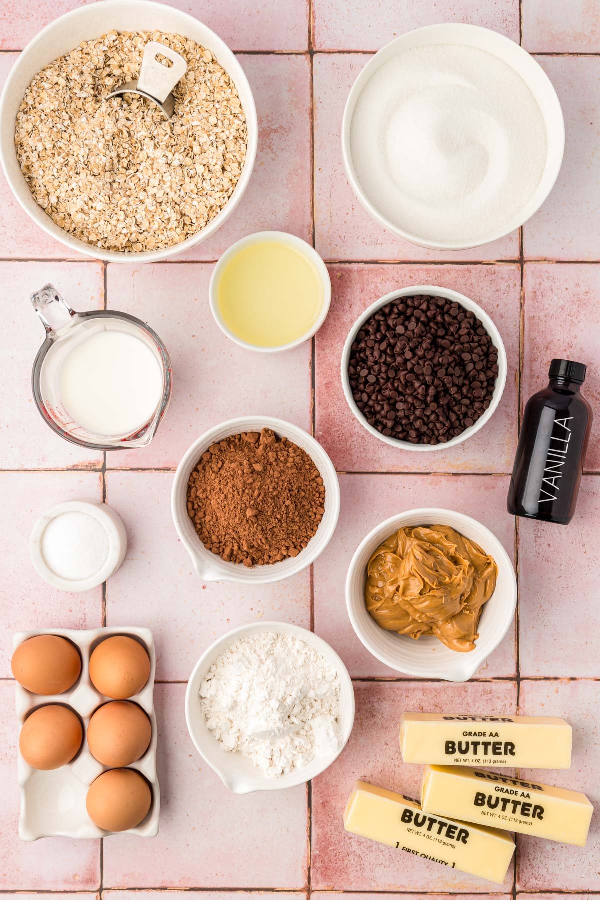 Ingredients to make no bake brownie cookies on a pink table.