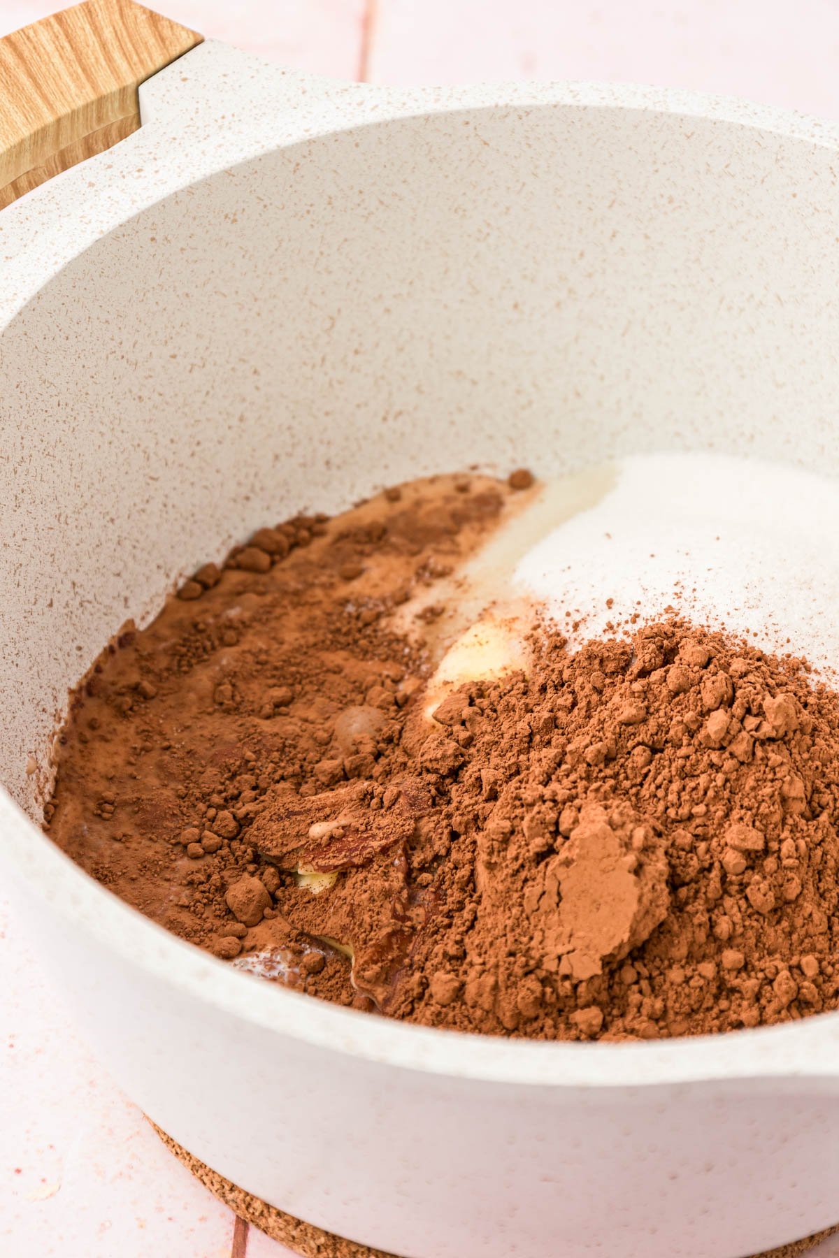 Cocoa powder, sugar, and butter in a pot.